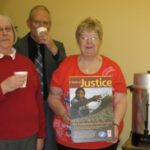 people drinking coffee and holding a poster