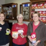 three people holding coffee