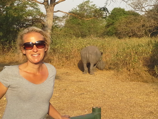 person next to rhino